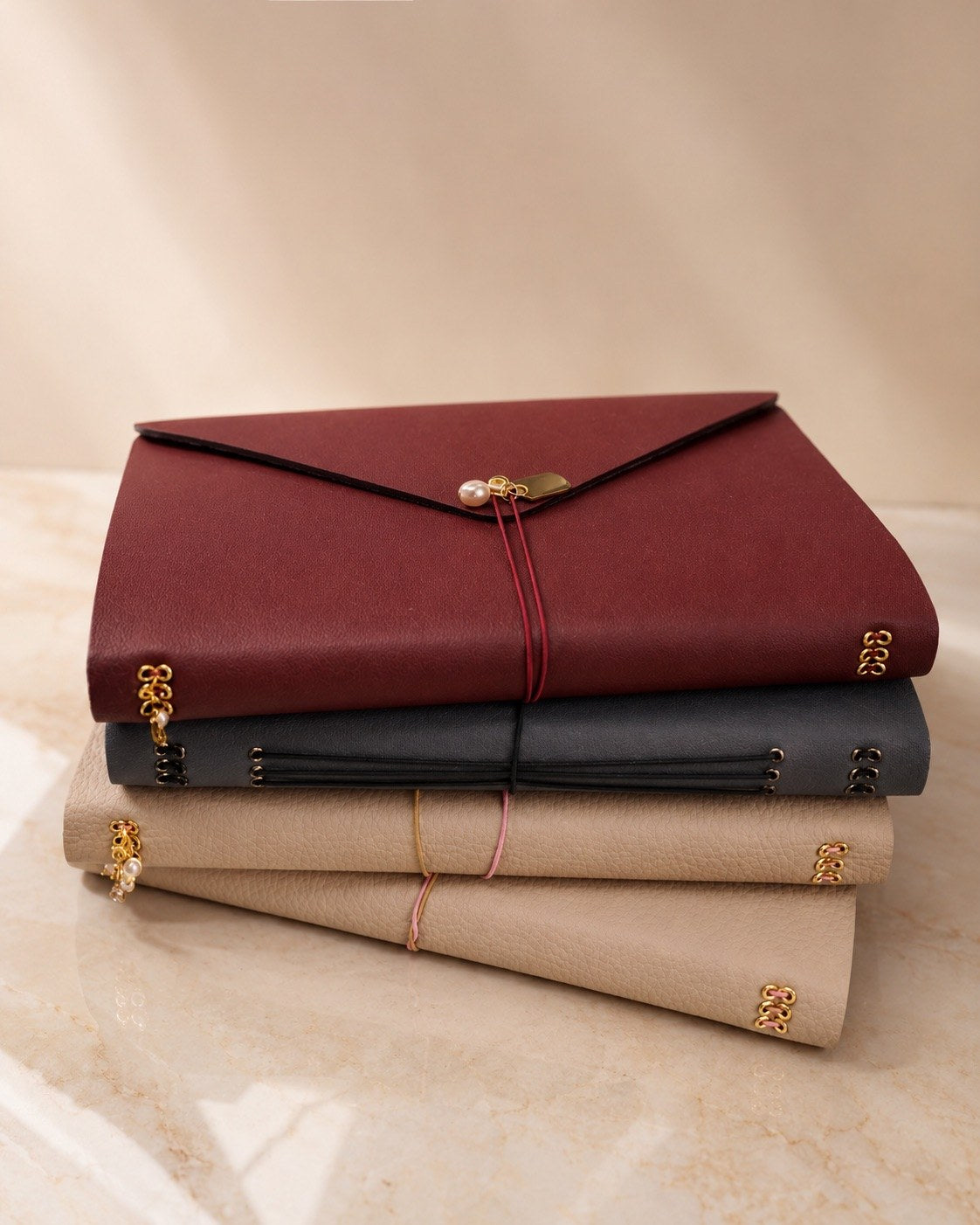 Burgundy and neutral covers in a stacked arrangement
