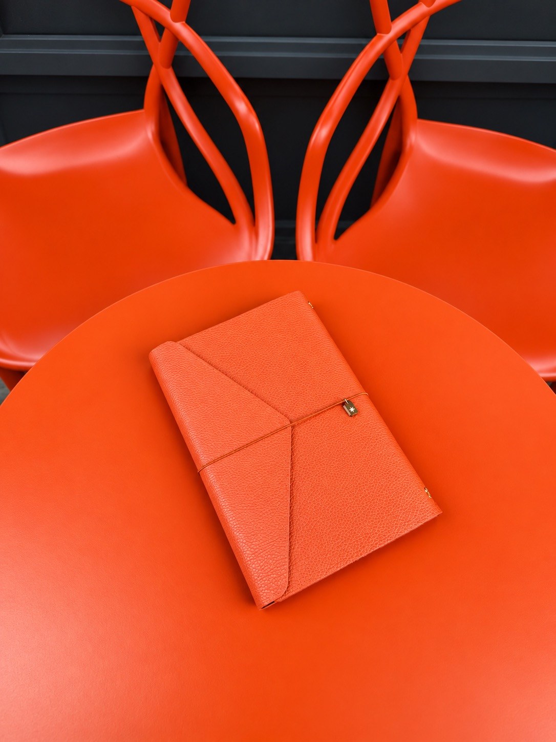 Orange leather notebook cover · cafe table