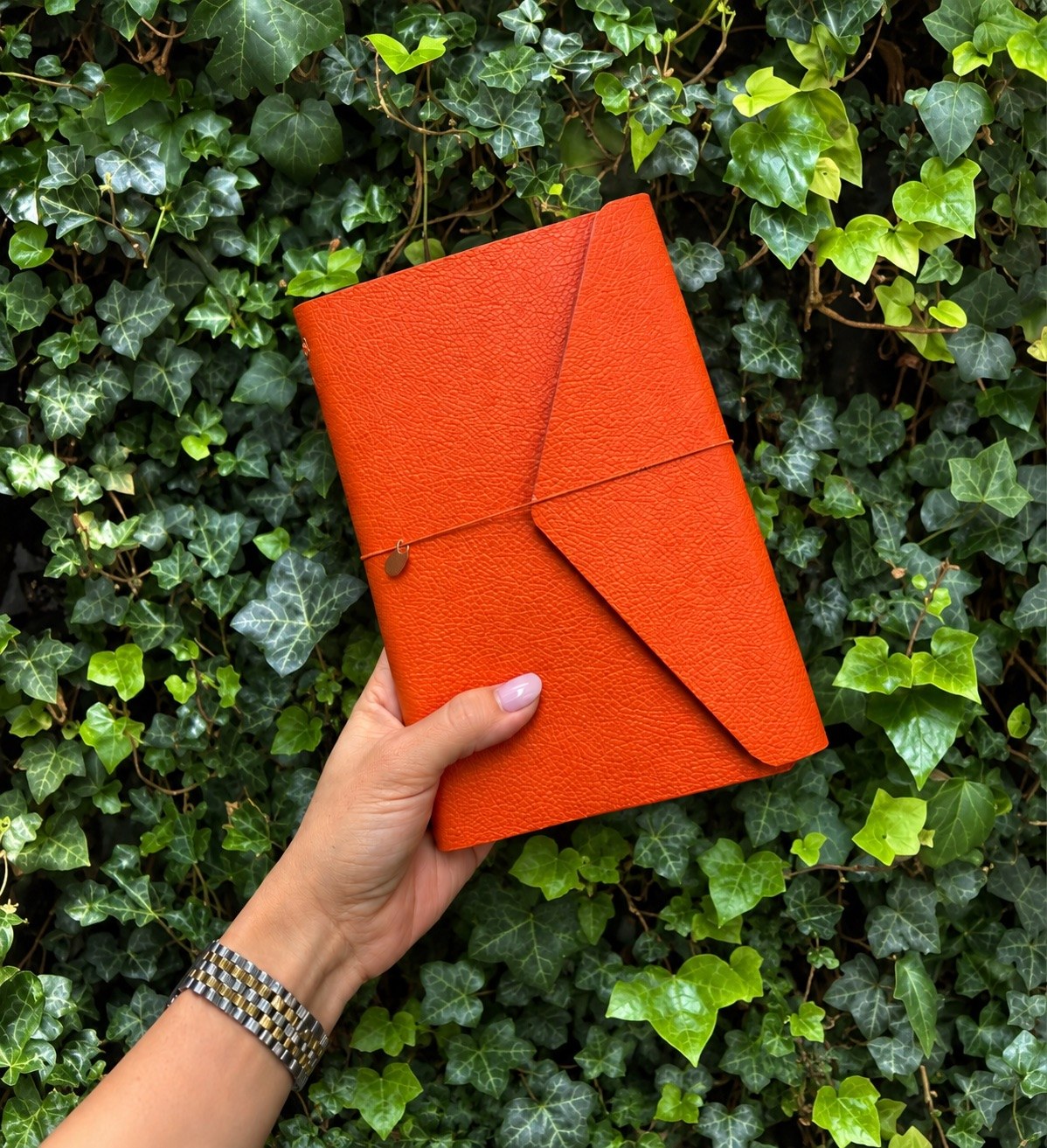 Orange leather notebook cover · greenery