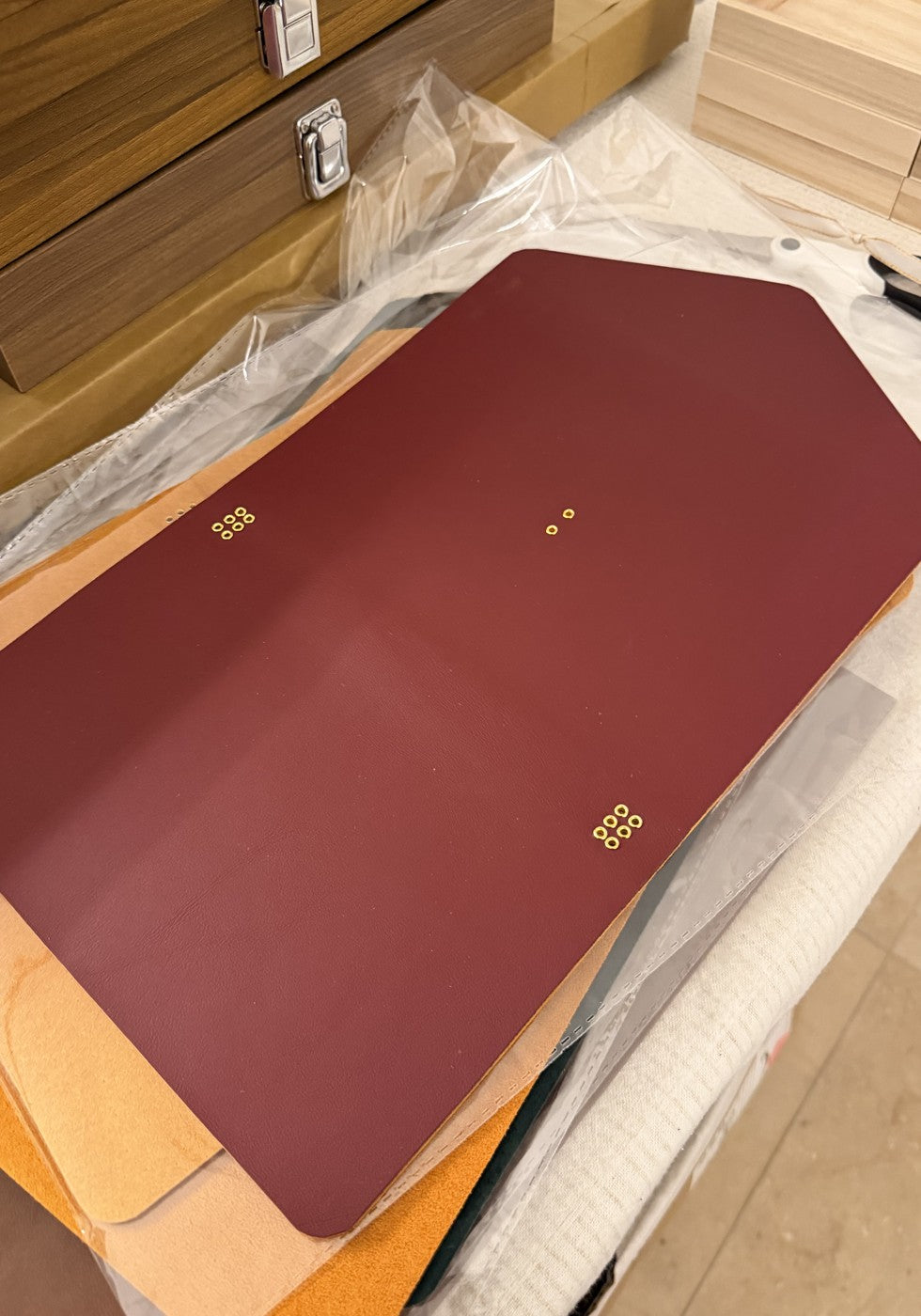 Burgundy trifold exterior leather panel, laid flat before assembly